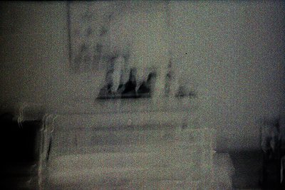 Vintage sepia-toned photo of blurred figures ascending stone steps, likely mid-20th century. Indoor staircase with muted ligh...