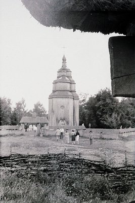 Vintage black-and-white photo of a **Ukrainian wooden church** (likely a **Hutsul-style** tower church) with a distinctive **...