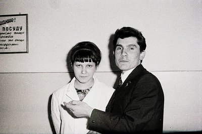 Black-and-white portrait of a man and woman in formal attire, likely Soviet-era (1960s–1980s). The man wears a dark suit with...