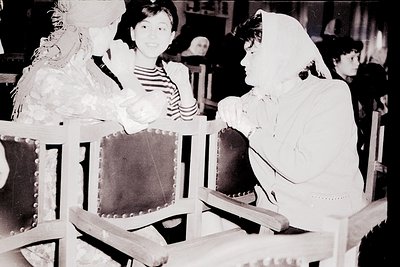 Vintage black-and-white photo of three women in period costumes seated on ornate chairs, likely from a 1950s–1960s theatrical...