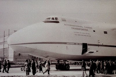 Antónov An-124 Ruslan cargo aircraft, "International Cargo Transporter," parked on tarmac with onlookers. Black-and-white pho...