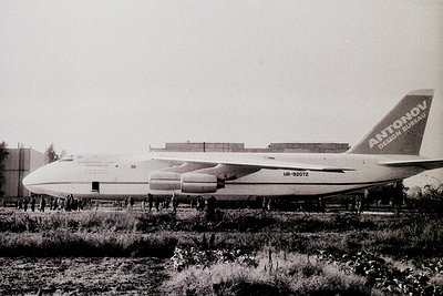 Antonov An-225 Mriya cargo aircraft on ground, likely during Soviet-era testing or transport. Crowd of onlookers gathered nea...