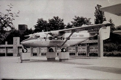 A Soviet-era seaplane (Aeroflot, USSR-19681) displayed on a concrete stand at an outdoor exhibition. High-wing monoplane with...