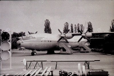Vintage four-engine turboprop aircraft, likely a Tupolev Tu-114, displayed outdoors with propellers in high-wing configuratio...