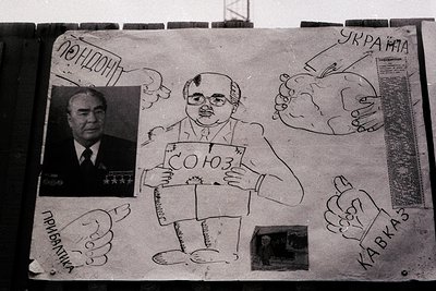 Satirical poster featuring caricatures of Soviet leaders with exaggerated features, including Leonid Brezhnev holding a sign ...