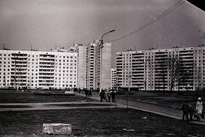 Mid-century Soviet-era apartment blocks in a planned urban complex, featuring Brutalist concrete architecture with repetitive...