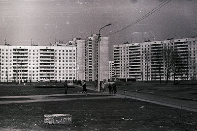 High-rise Soviet-era apartment blocks in a barren urban landscape, likely Eastern Europe, 1960s–1980s. Brutalist concrete arc...