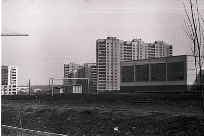 Mid-century Soviet-era apartment blocks under construction, featuring Brutalist concrete architecture with exposed formwork. ...