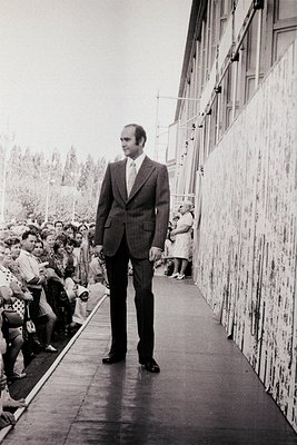 Richard Nixon walks a designated path flanked by a crowd at the 1969 Prague Spring solidarity rally, Czechoslovakia. His suit...