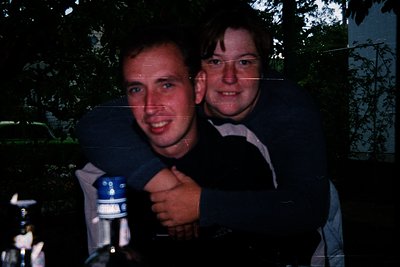 Vintage candid shot of two individuals posing with a blue Darth Vader-style prop in a wooded area, likely late 1970s–early 19...