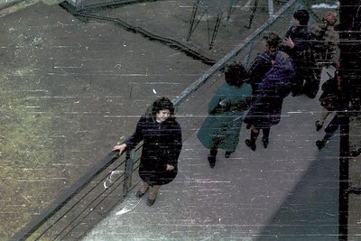 Reflection of 1970s urban commuters descending a glass-walled staircase, likely in a Soviet-era building. Distinctive layered...