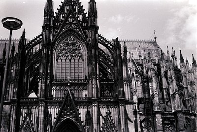 Gothic cathedral façade featuring intricate tracery, pointed arches, and rose window—likely Cologne Cathedral (). Symmetrical...