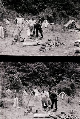 Mid-20th century archaeological excavation site in a forested area. Four individuals—three shirtless, one in long sleeves—wor...