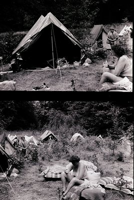 Mid-20th century camping scene in a forested area, likely 1950s–1960s. Tents pitched on uneven terrain with makeshift wooden ...