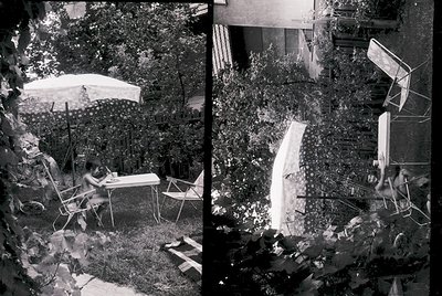 Mid-century outdoor dining scene with vintage metal furniture under a large umbrella. Left: person seated at a round table wi...