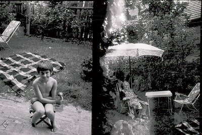 Mid-century backyard scene featuring a young boy squatting on concrete, surrounded by vintage patio furniture. Right side sho...