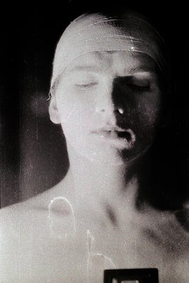 Black-and-white portrait of a person wearing a swim cap, likely mid-20th century. Soft focus and low lighting emphasize seren...