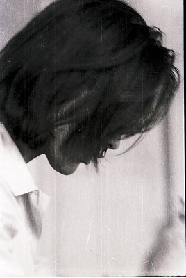 Portrait of a person with short, voluminous hair in a classic side profile. The style suggests mid-20th century fashion, like...
