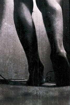 Close-up of a **classical marble statue** depicting a dynamic male figure in mid-stride, likely from the **Hellenistic or Rom...