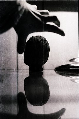 Close-up of a chess piece (king) in mid-air, captured via reflection on a glossy surface. The composition suggests motion blu...