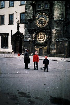 1960s Prague: A family poses in front of Prague’s Astronomical Clock, a 15th-century Gothic masterpiece. The adult wears a cl...