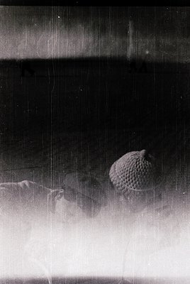 Vintage black-and-white close-up of a **knitted textured ball** resting on a **curved surface**, likely a vintage sweater or ...