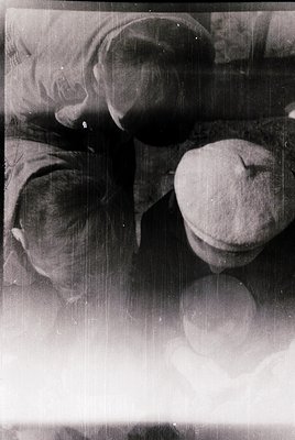 Vintage black-and-white photo of three vintage-style hats with wide brims, likely 1940s–1960s. Soft focus and slight film gra...