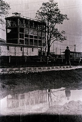 Mid-20th century industrial waterfront structure with multi-level observation tower, likely a lighthouse or control station. ...