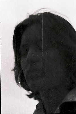 Vintage black-and-white portrait of a person in profile, likely mid-20th century. Side lighting accentuates facial contours, ...