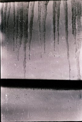 Vintage slide frame showing vertical streaks of faded color, likely from a degraded or scratched slide. The frame’s metal edg...