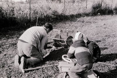 Vintage black-and-white photo of two men operating a **Rapo-SP** soil compaction tester in an open field, likely for agricult...