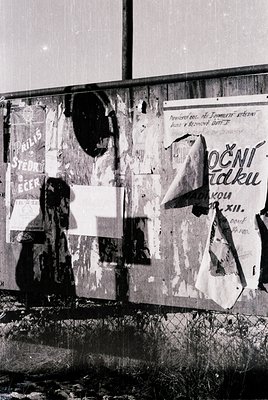 Peeling wall mural featuring Cyrillic text and faded posters, likely from Eastern Bloc era. Prominent sign reads "ПОВЕРИТЕ СЪ...