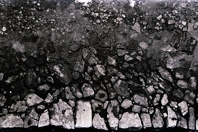 Rough-hewn stone wall with irregular, angular blocks in a dry-stack technique. Likely constructed for durability in rugged te...