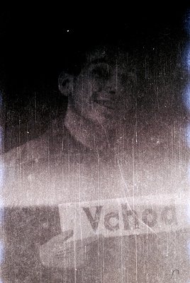 Vintage black-and-white ad featuring a smiling man behind a rain-soaked window with "Vanco" logo. Likely 1950s–1960s American...