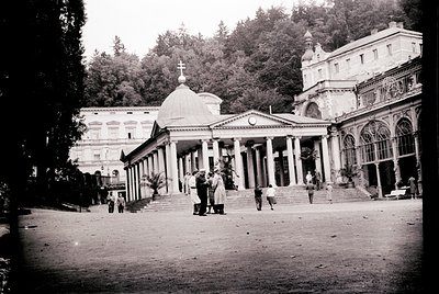 Neoclassical seaside resort complex with grand colonnades, domed pavilion, and arched verandas. Mid-20th century architecture...