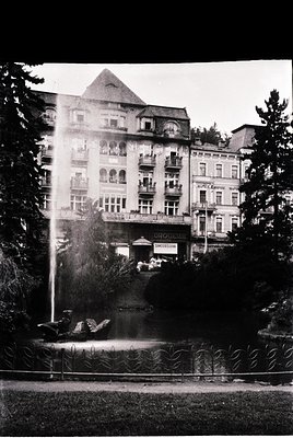 Historic alpine resort hotel with Art Nouveau façade, featuring ornate balconies and a central tower. A prominent fountain wi...