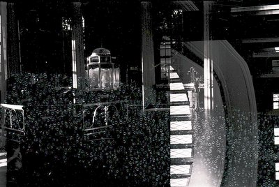 Black-and-white reflection of a grand staircase and ornate interior through rain-splattered glass, likely a historic European...
