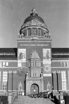 Exterior view of the Naturhistoriska Riksmuseet building. Large banners are displayed on the facade, including one featuring ...