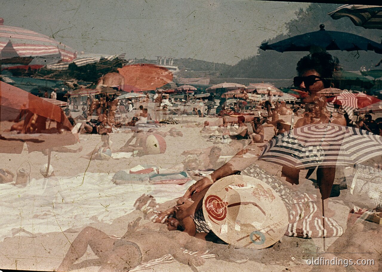 Vintage seaside scene with striped beachwear and vintage umbrellas. Crowded sandy shore with sunbathers, deck chairs, and scattered towels. Coastal landscape with rocky outcrops in background. Likely Mediterranean or Adriatic region, 1950s-1960s.