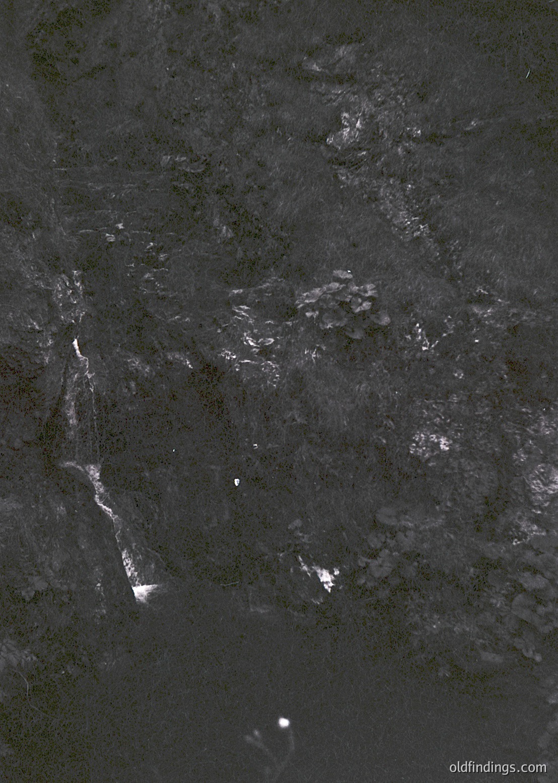 High-contrast aerial nighttime shot of urban sprawl, likely from satellite or drone. Distinctive bright city lights outline a river valley, with dense clusters in the center and sparse outskirts. Resembles a major Eastern European city, possibly or . Style suggests 1990s–2000s satellite imagery. Useful for urban planning, historical geography, or night photography references.