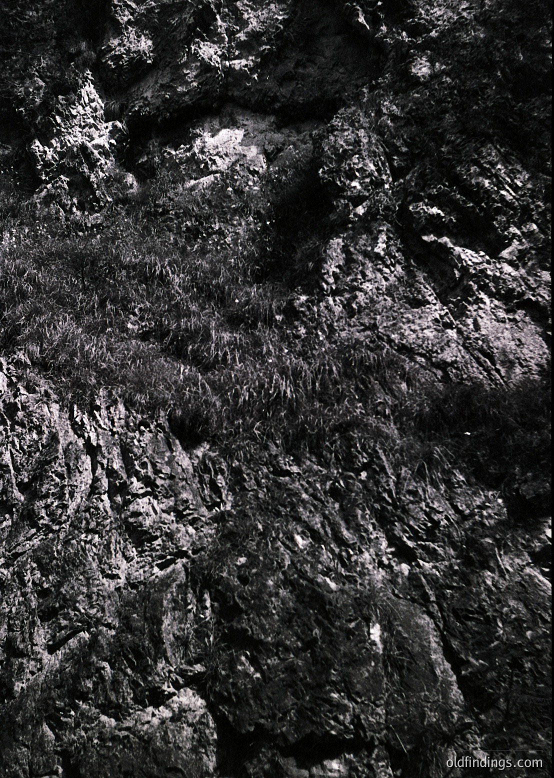 High-contrast close-up of weathered, textured stone wall with intricate erosion patterns. Likely limestone or sandstone, showcasing natural erosion and mineral deposits. Ideal for architectural texture references or geological studies.