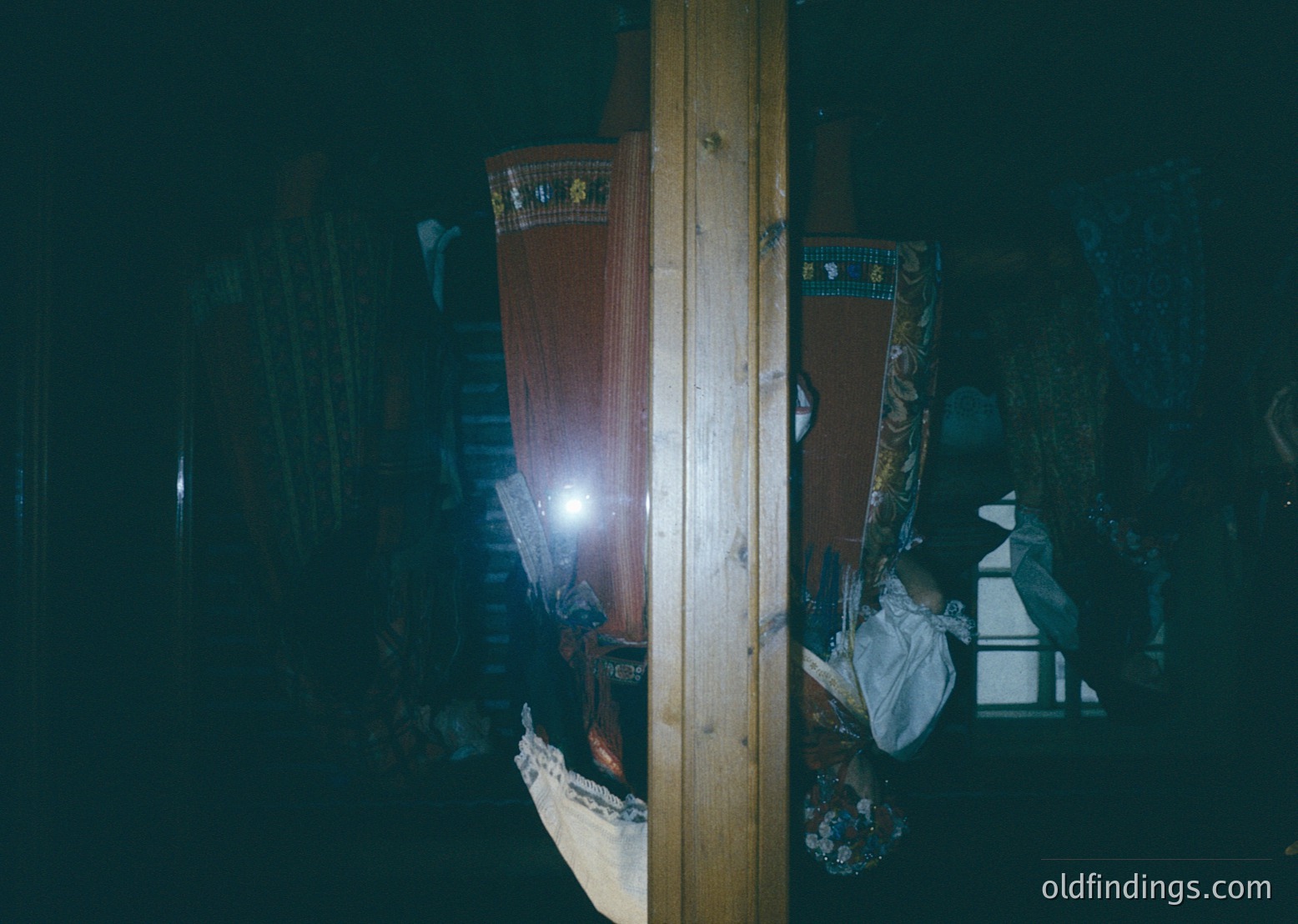 Low-angle shot of a dimly lit interior featuring traditional embroidered textiles and wooden beams. The patterned fabric suggests Eastern European folk craftsmanship, likely from a rural setting. The warm light source highlights intricate floral designs. --- *Note: Without clearer visual cues or metadata, the time period is inferred as 19th century based on style. For stock/design use, emphasize "textile patterns" and "vintage interior."*
