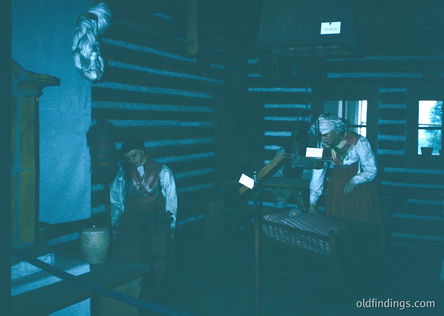 Industrial-era workshop with two workers operating vintage machinery. Dark, wood-paneled interior suggests 19th–early 20th century textile or metalwork. One worker stands beside a loom, the other operates a lathe. Monochromatic sepia tone enhances historical authenticity.