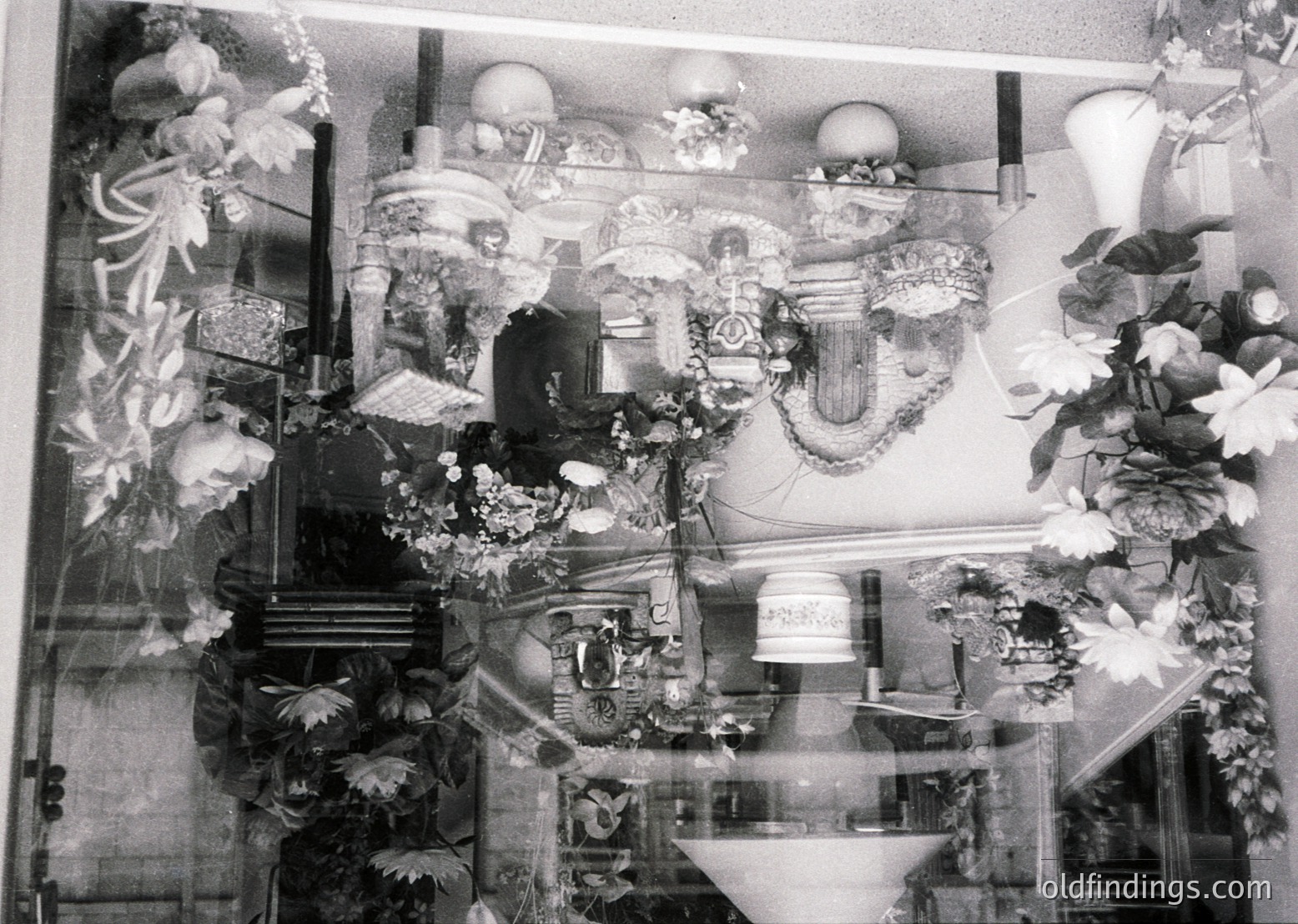 Elaborate 19th-century wedding reception hall with ornate floral arrangements, chandeliers, and mirrored walls reflecting opulent decor. Intricate wall murals depict classical motifs. Likely European, possibly .