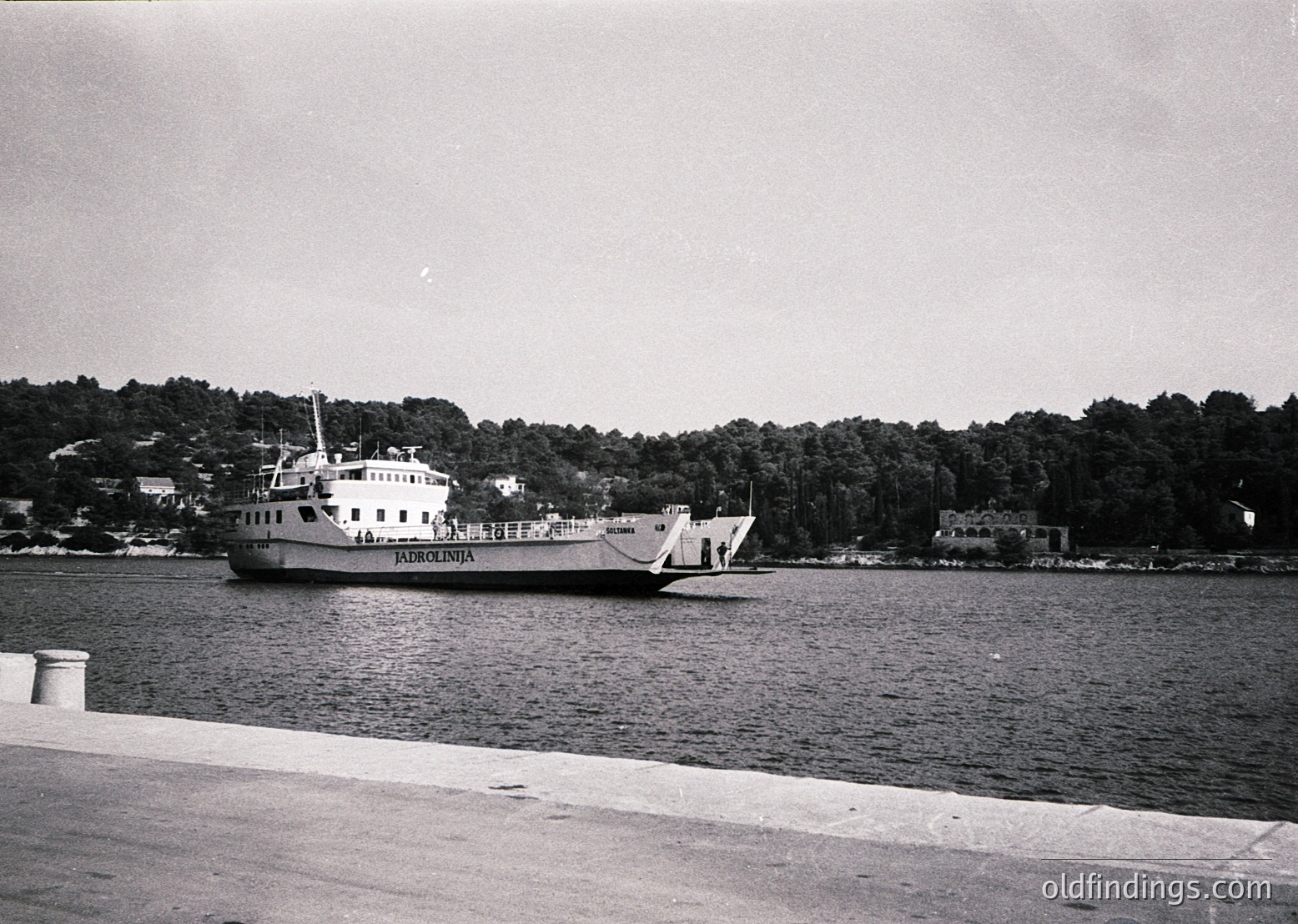 Mid-20th century ferry "Pardunlenia" navigating calm waters, likely a Bulgarian Black Sea route. Wooden pier and forested coastline in background suggest or . Classic maritime design reflects ferry architecture.