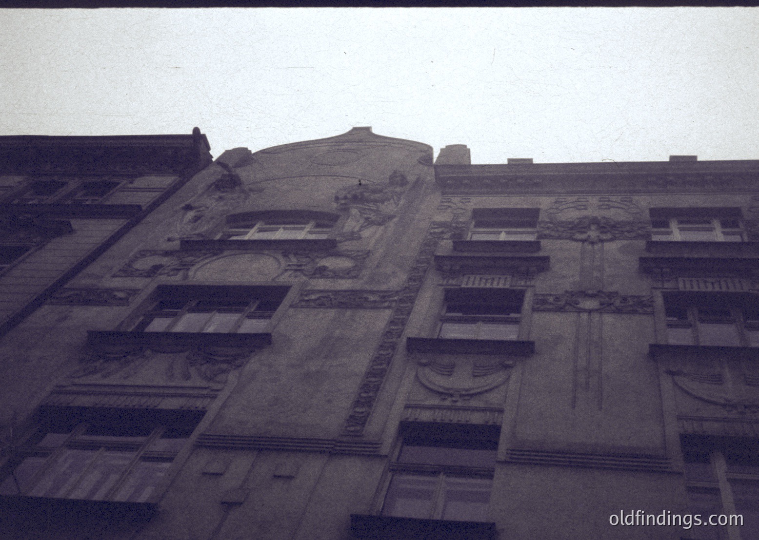 Art Deco-inspired façade featuring sculpted reliefs, geometric window frames, and decorative balconies. Likely mid-20th century urban architecture.