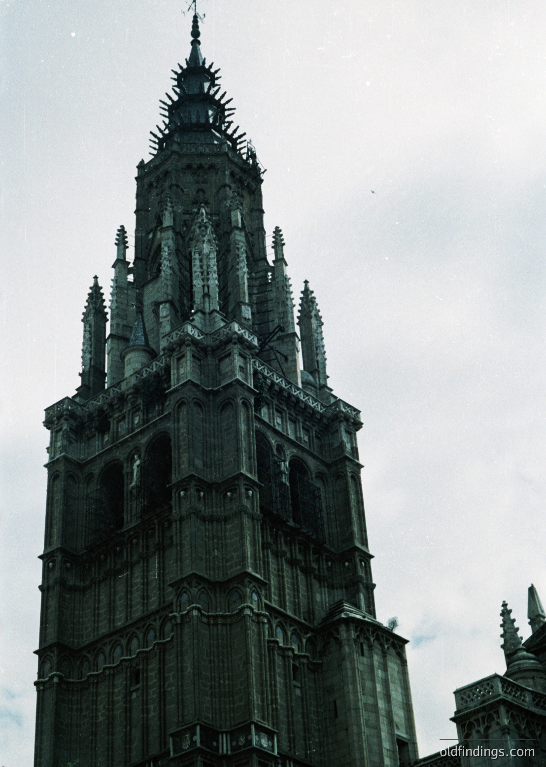 Gothic-style church tower with intricate stone tracery, spires, and buttresses, likely European