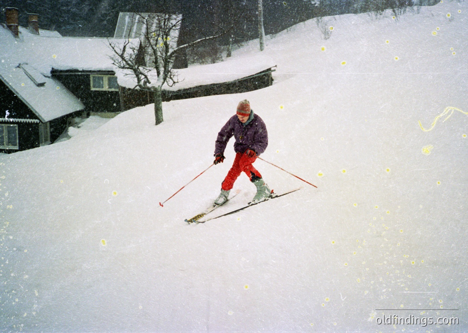 A skier in classic alpine gear descends a groomed slope, surrounded by snow-covered chalets. Mid-20th century winter sports attire includes a purple jacket, red pants, and vintage skis with red tips. Snowflakes and sunlight create a dynamic winter atmosphere.