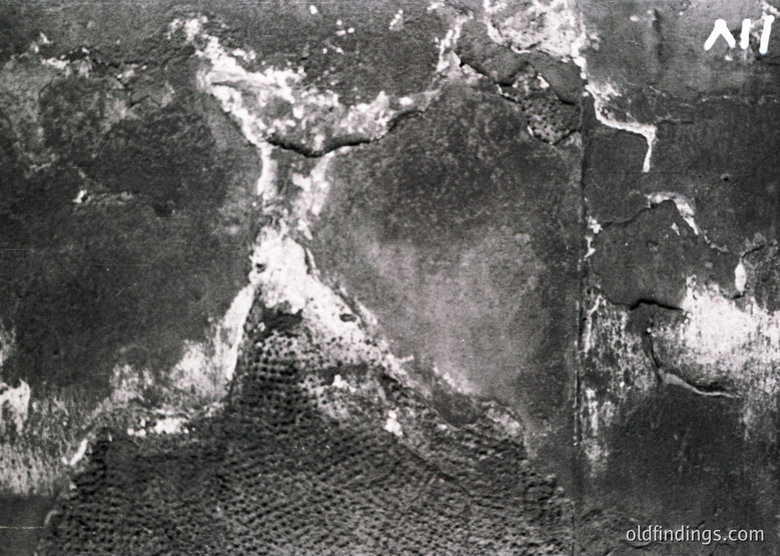 Aerial black-and-white photo of a coastal landscape showing eroded cliffs and a narrow beach. Distinctive rock formations and tidal patterns visible. Likely Eastern European coastline, mid-20th century.