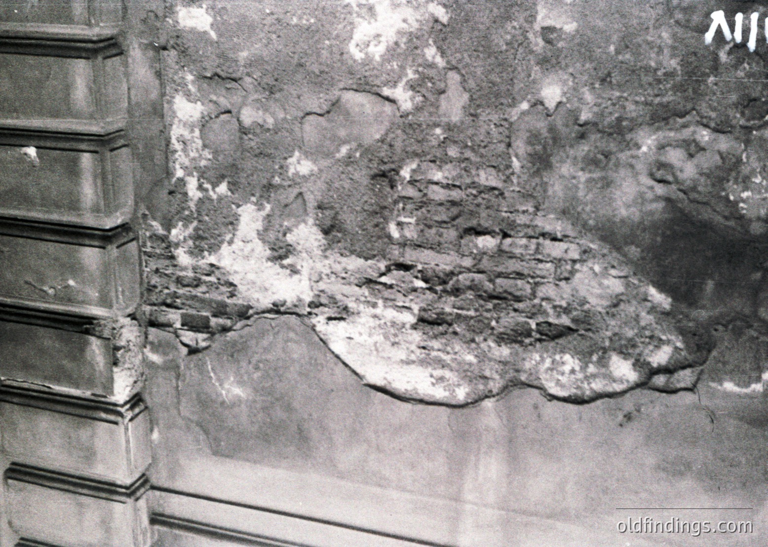 Close-up of deteriorated plaster revealing exposed brickwork, likely from a historic European building. Cracks and peeling suggest structural aging or damage. Potential --- *Note: If this is from a specific region/country, additional tags like could be added if identifiable.*